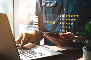person on computer rating