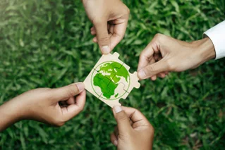 hands making globe puzzle
