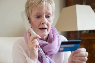 woman on phone with credit card