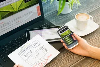 a person with many devices for web design